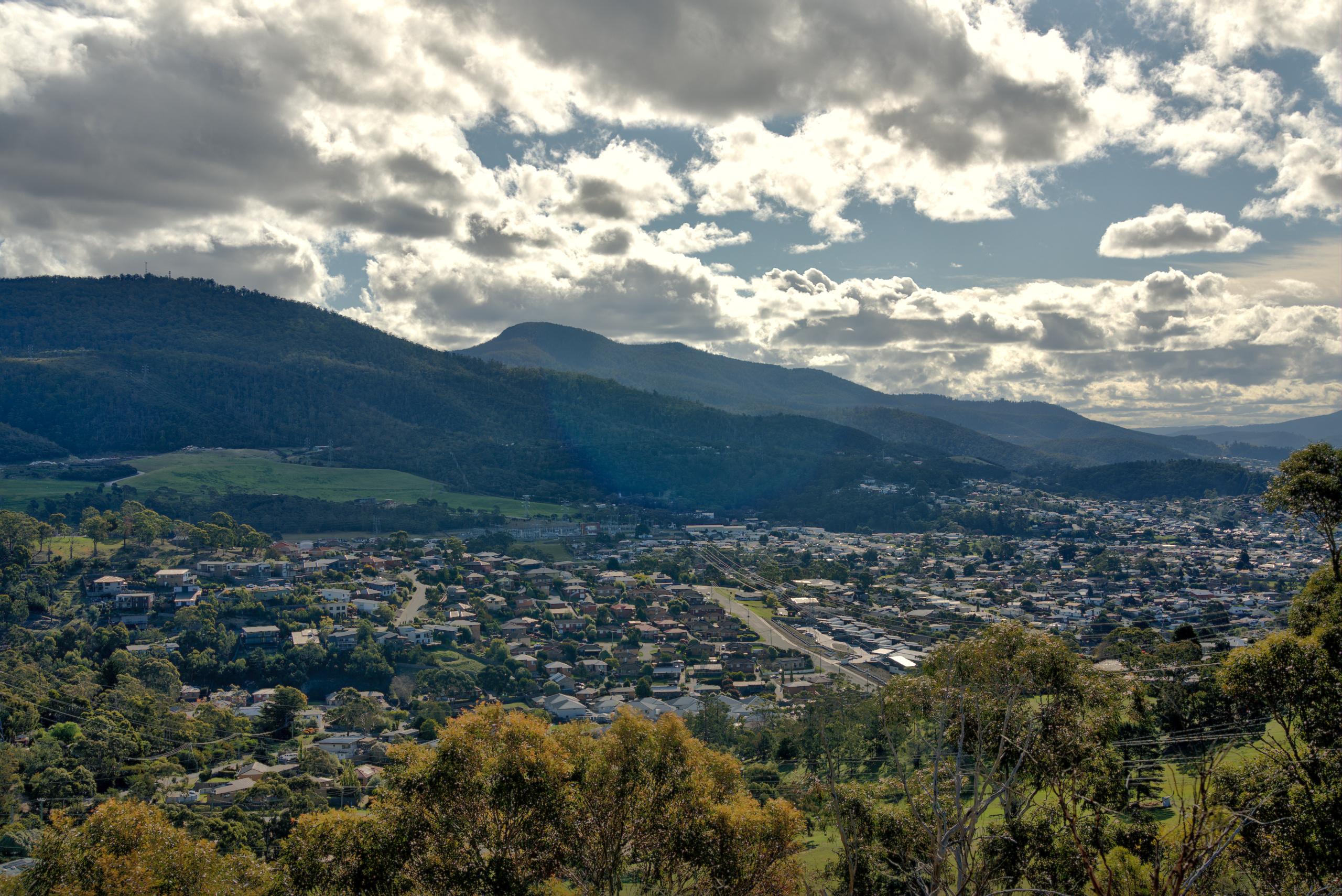 View from the property across Lenah Valley to the hills, under a broken sky.